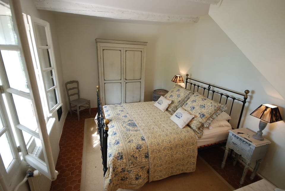 Bedroom with a view out to the pool and Mont Vaucluse 