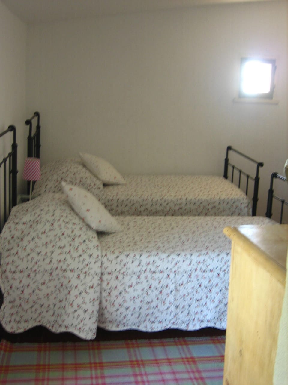 Twin bedroom with a view out to the pool