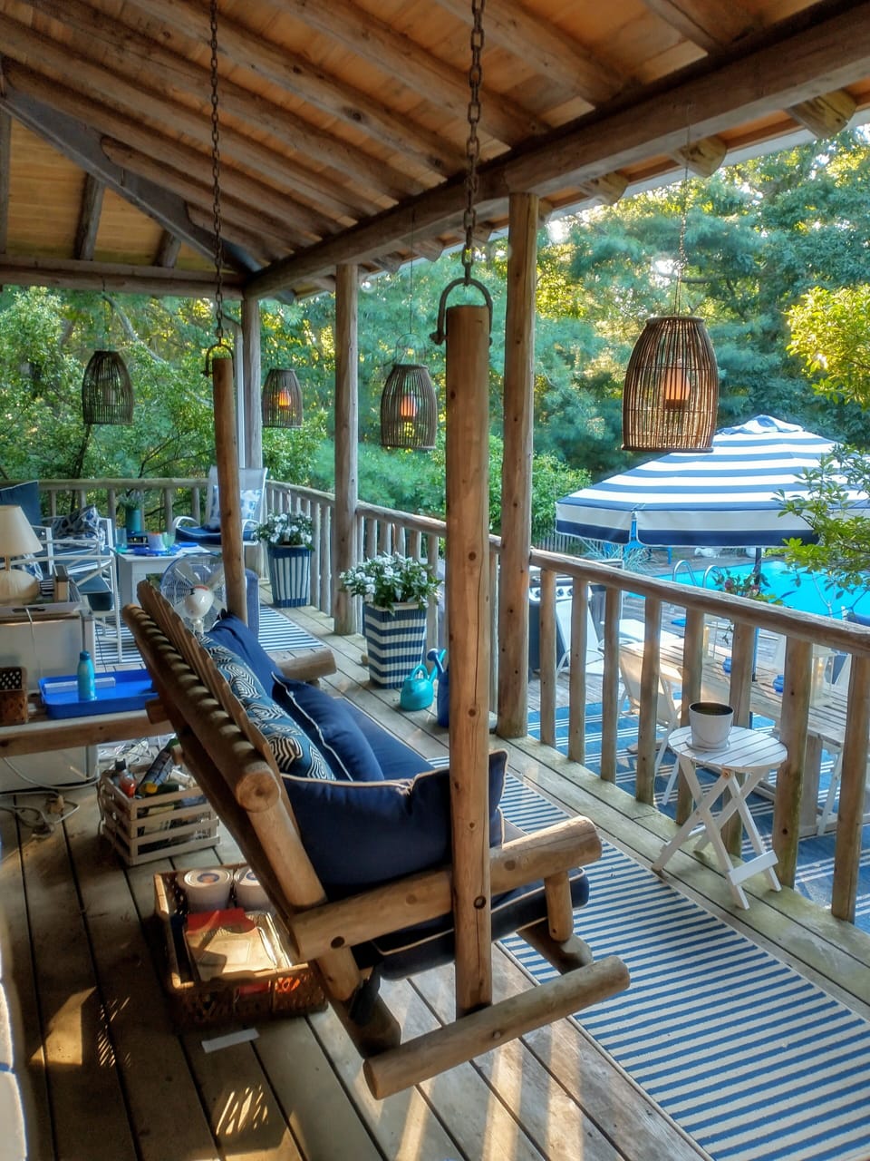 large back porch overlooking pool with swing and seating