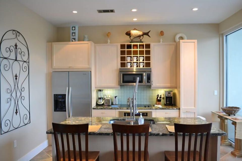 Fully stocked kitchen with stainless appliances, granite counters, pantry, and bar seating for 3. Keurig and regular coffee pot.
