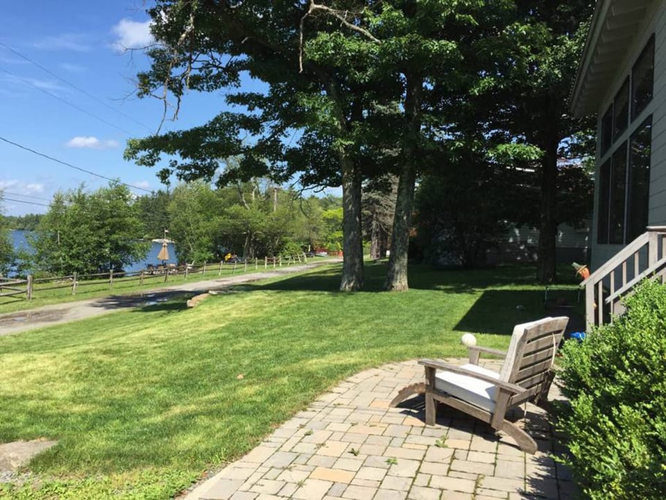 Beautiful lawn for lawn games! Sunbathing pavers next to the house. 