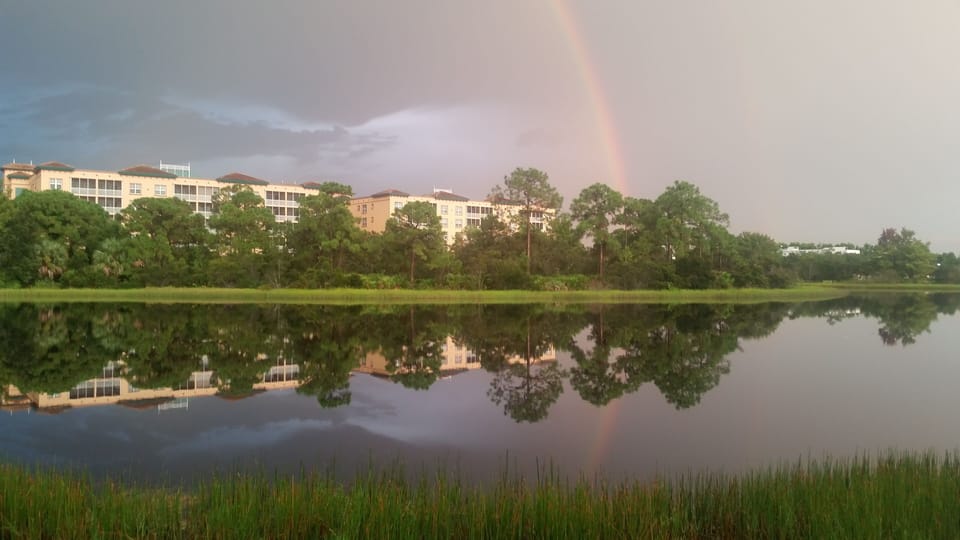 Rainbow view from condo over a lake of glass