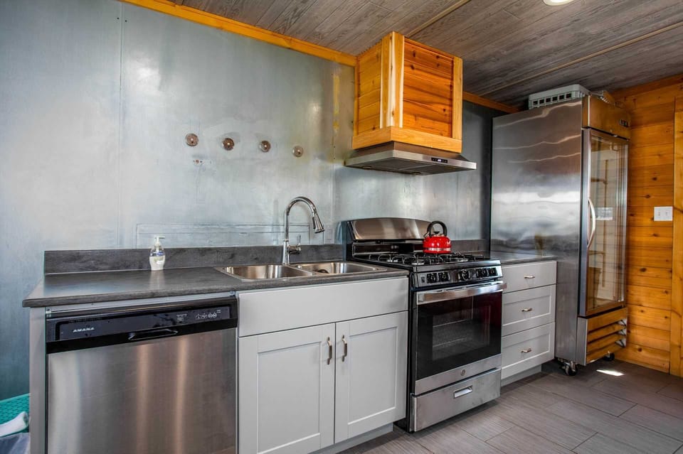 This is a true chef's kitchen, packed with gleaming modern appliances, including a commercial-grade range top and oven!