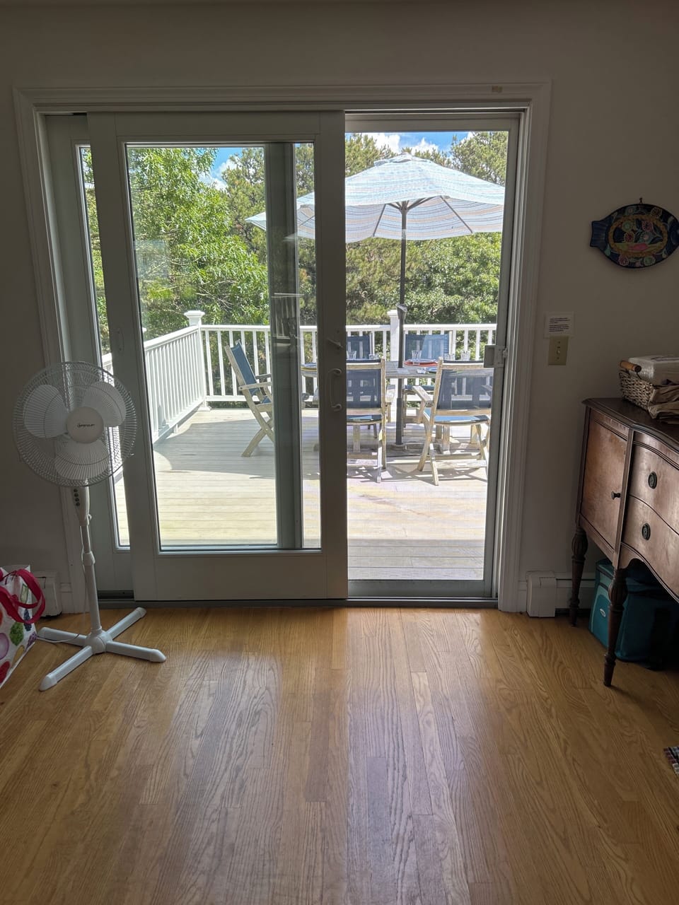 View from dining room to deck. Kitchen is to the right and dining table to left.