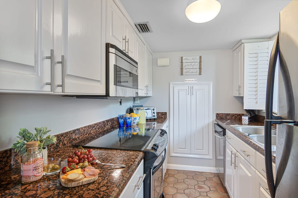 Kitchen looking west from dining room. Large window with ocean view at sink!😀