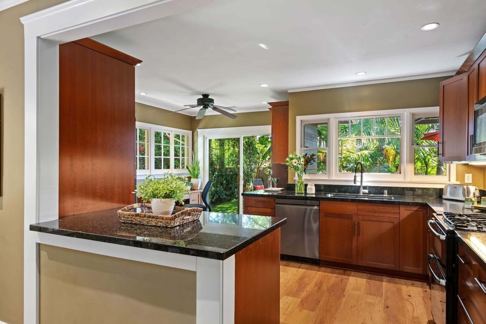 A fabulos cooks kitchen is sunny and bright. The location just off the back terrace makes mealtime convenient and easy too!