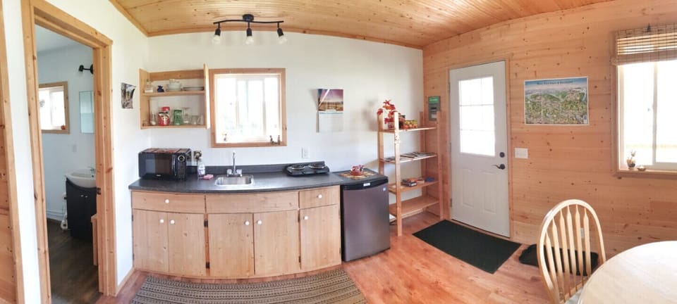 kitchenette with fridge, hotplate, microwave, kettle, toaster, and coffee maker