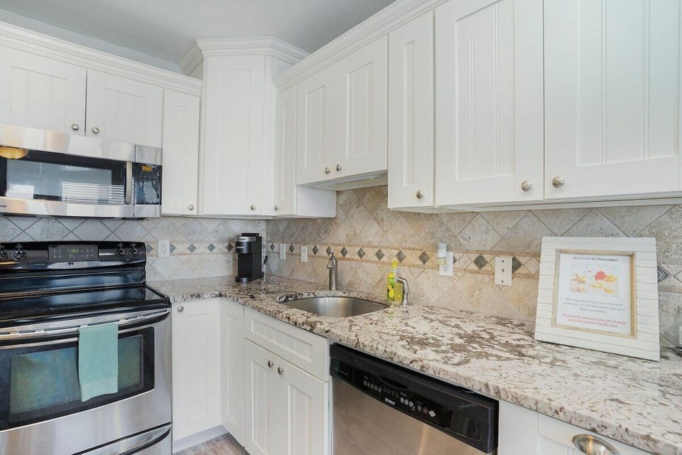 Stainless appliances including frig, oven and dishwasher along with Keurig