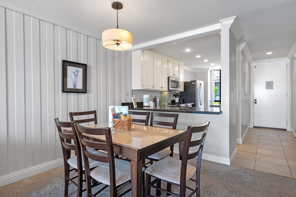 Comfortable dining setup with warm lighting and modern coastal charm