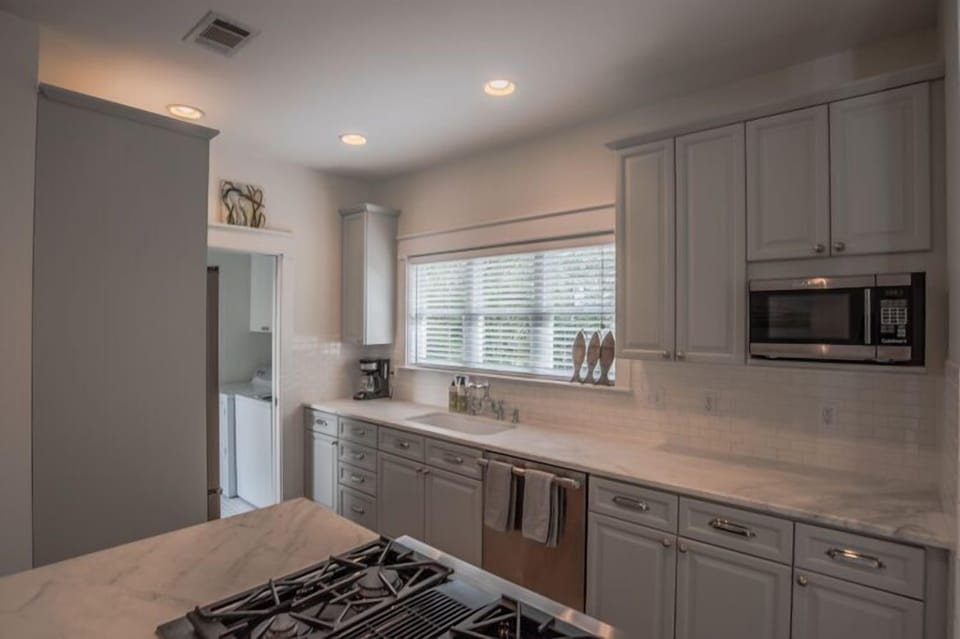 Fully stocked kitchen and laundry area accessible from the back door and outdoor shower area