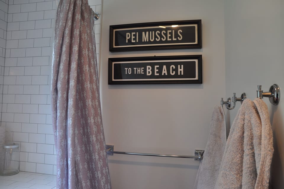 Main floor bathroom with tub and rain shower