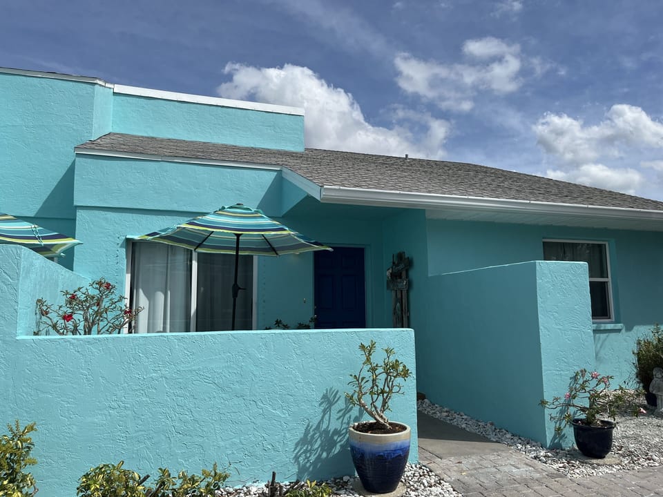 Beach House front entrance on the right. Parking for two car 