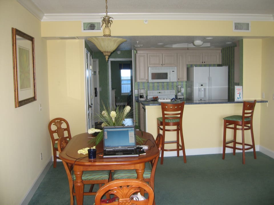 kitchen view from living room. pineapple design in chairs.