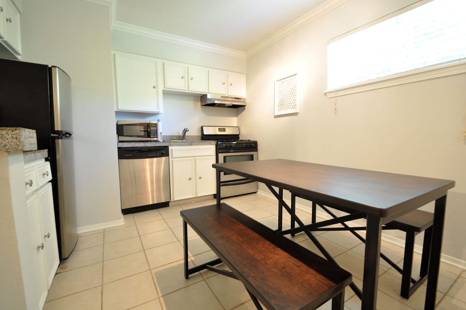 Fully Functional Small Kitchen has a nice dining table with benches seats up to 