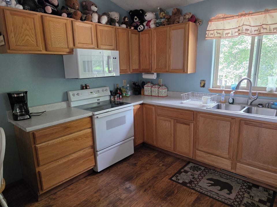 Kitchen with electric stove, microwave, coffee maker