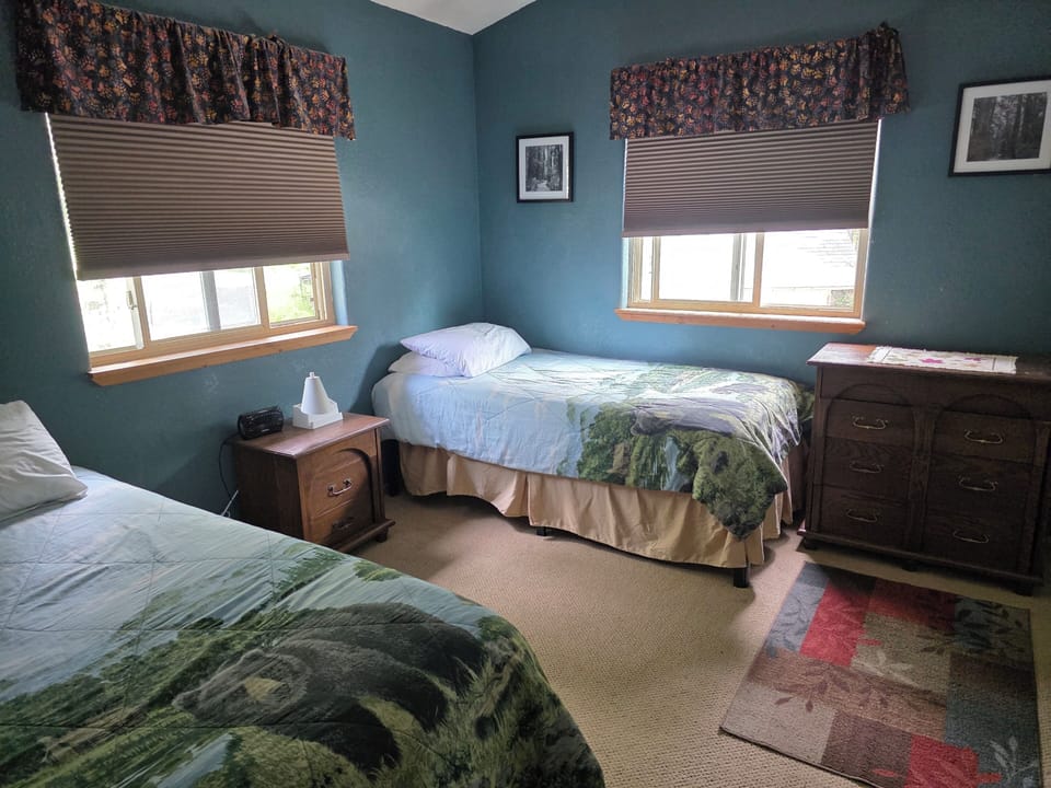 Two twin beds, dresser, darkening blinds