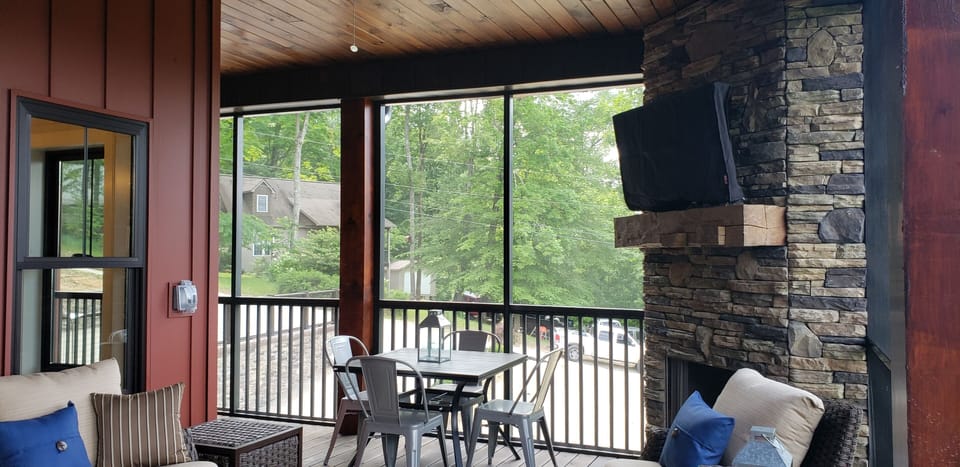 Screened-in porch area with outdoor t.v., gas fireplace, plenty of seating