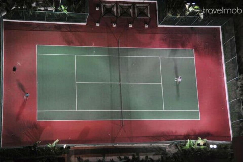 Tennis court, floodlit at night