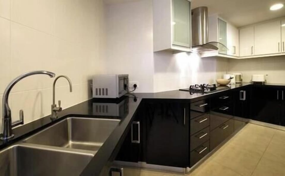 Kitchen with twin sink, granite worktops, filtered water, microwave, gas stove, blender, kettle, toaster, rice cooker