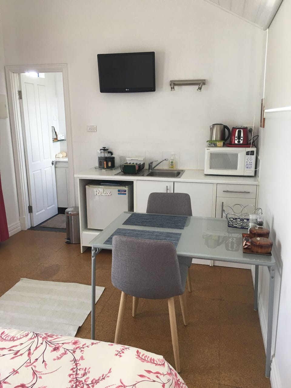 Kitchenette and dining area/bar fridge, microwave, single electric burner.
