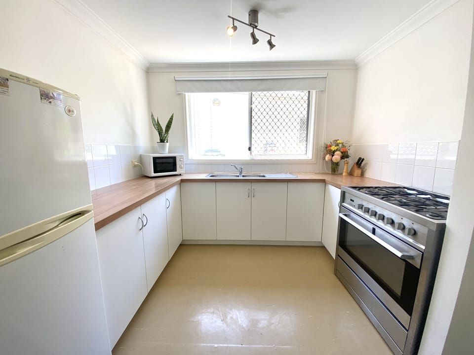 Fully equipped kitchen with large cooktop and oven