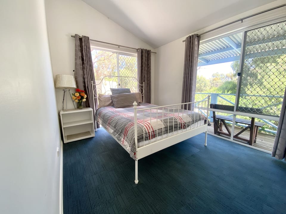 Master bedroom with queen size bed overlooking the deck