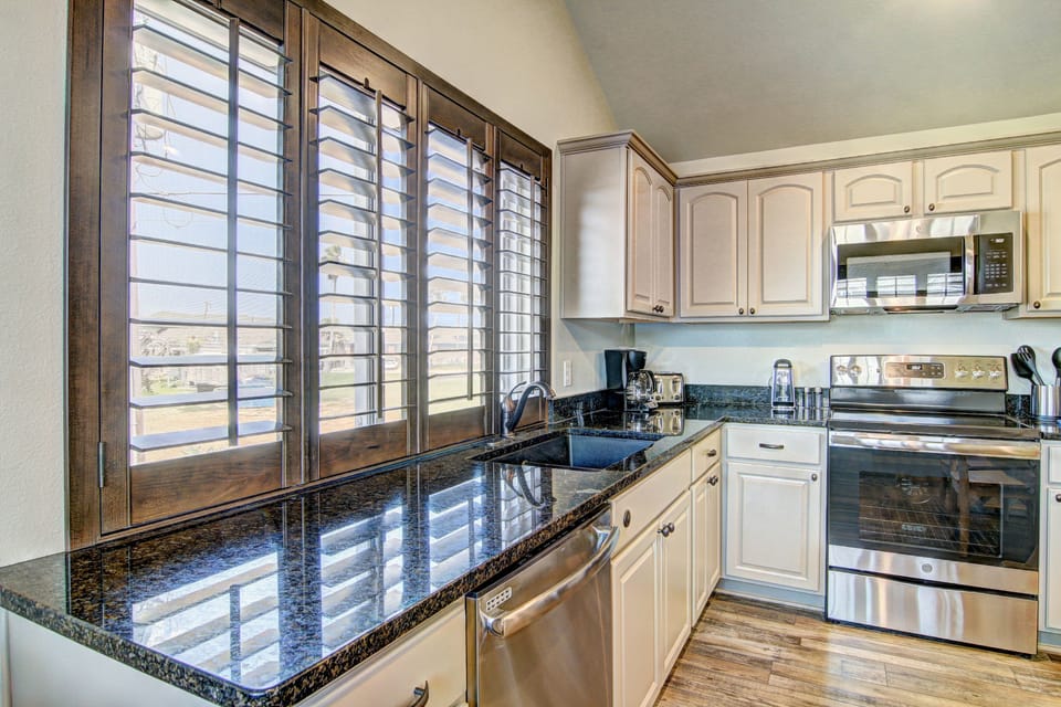 Kitchen - Open kitchen layout with plenty of counter space and coastal charm
