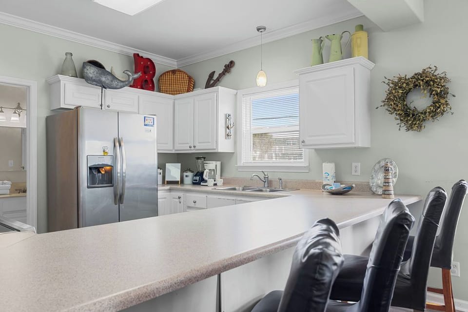 Kitchen - The kitchen features a large bar which is perfect for serving meals and seating additional guests for mealtime.