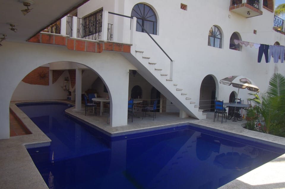 pool deep end and waterfall
and poolside lounge area