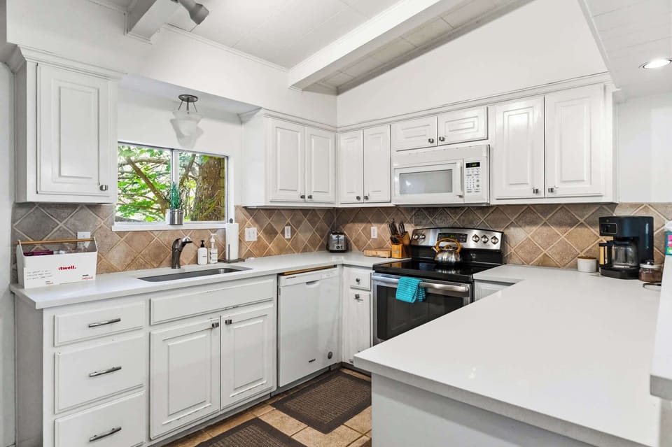 Kitchen area (complete with a sink, countertop, fridge, microwave, stove, utensils, coffee maker)