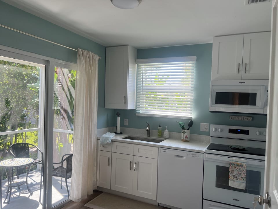 Full equipped and remodeled kitchen with view of screened in porch 