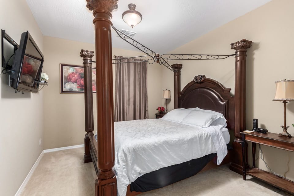 Bedroom five on main level with queen size bed.
