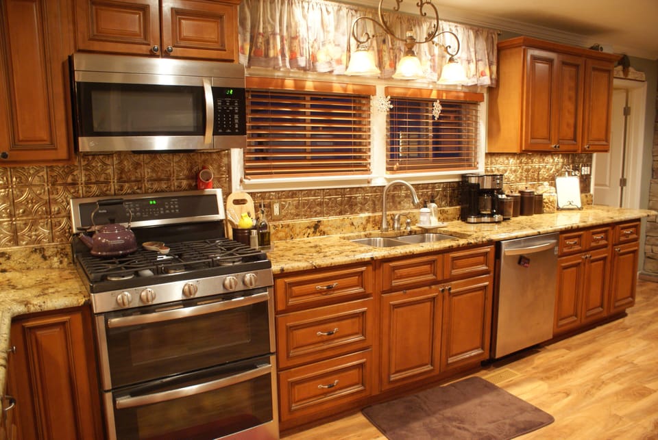 Full kitchen with gas stove, microwave, dishwasher and granite counters