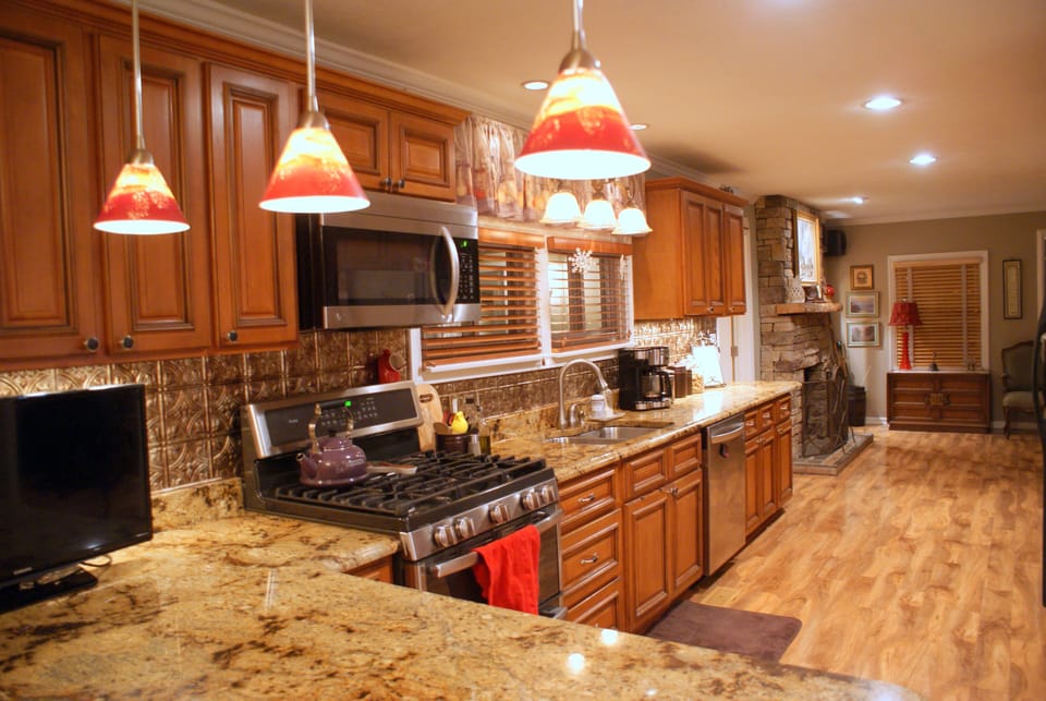 Full kitchen with gas stove, microwave, dishwasher and granite counters