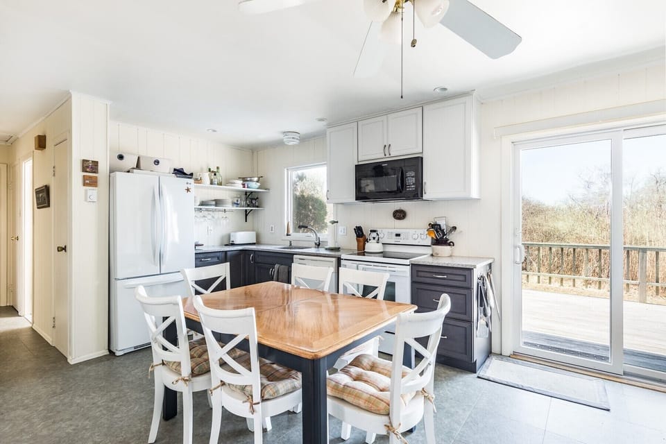 Kitchen now w/ SS gas stove leading to west facing deck. Separate Washer & Dryer