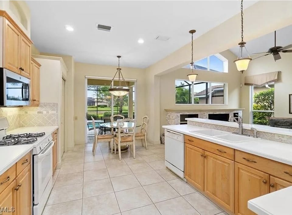 Kitchen with sliders to pool area and connected to great room (Living room)