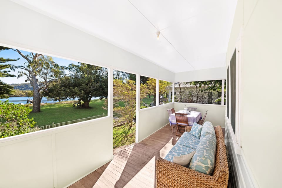 Outdoor seating and dining area overlooking Patonga Creek