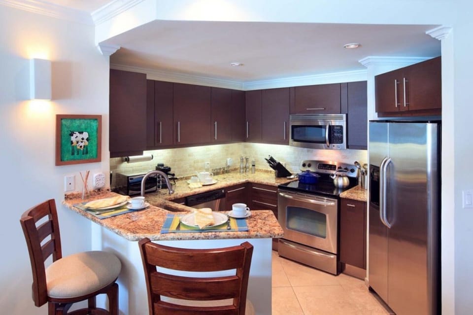 Kitchen with fridge, stove, dish-washer, coffee maker and microwave oven.