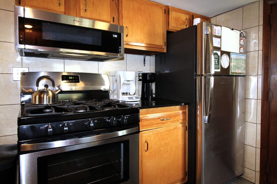 The fully equipped kitchen furnished with all the amenities you need, including a K-cup coffee brewer, blender and full size stainless steel refrigerator with automatic ice maker.