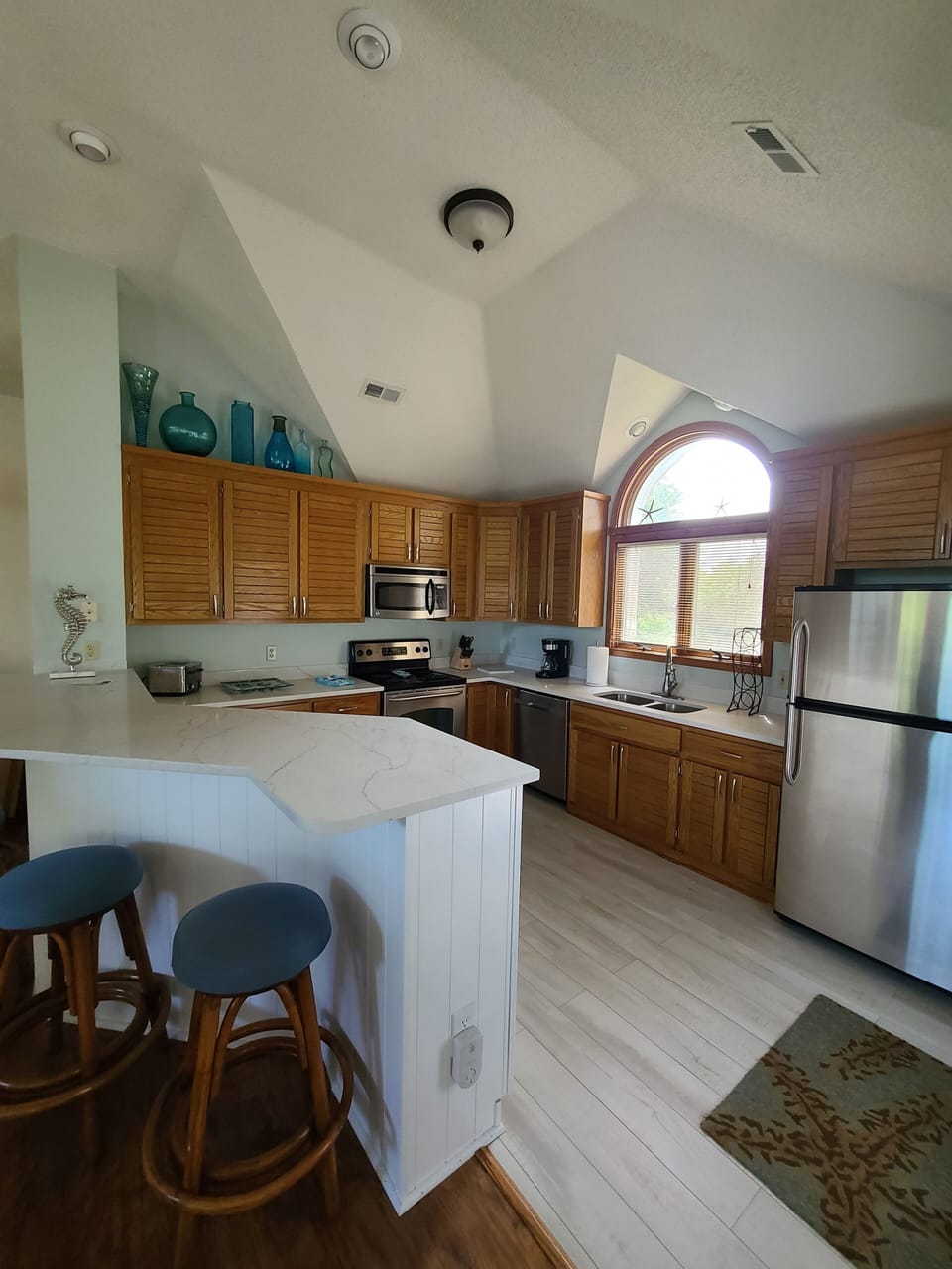 Well Equipped Kitchen with Quartz Countertops and Bar