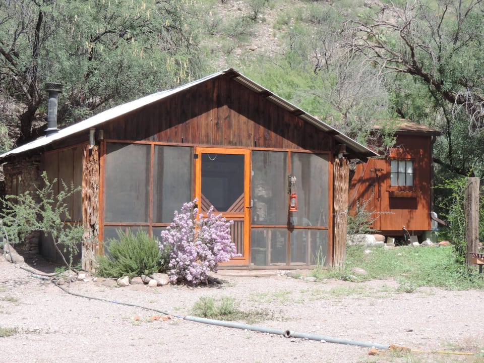 bathhouse is to the right of the cabin