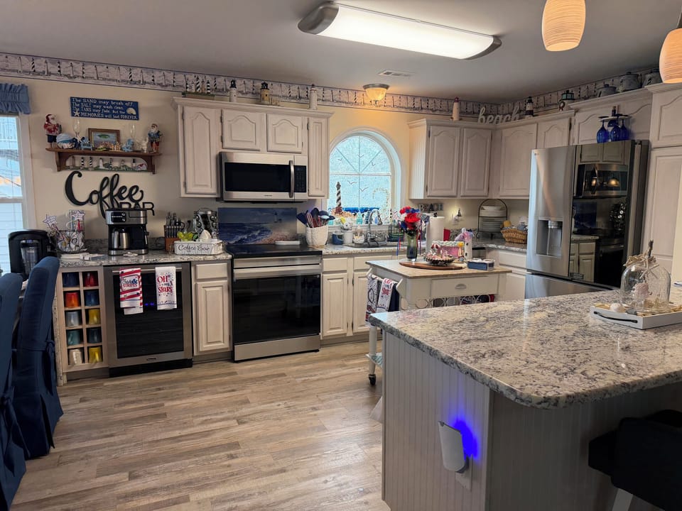 Kitchen with convection over and stove with large LG refrigerator. 
Coffee bar and beverage frig. for extra storage.
Air fryer and extra ice maker available. 