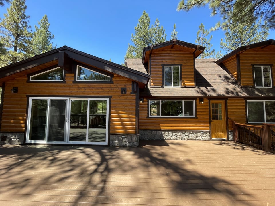 Expansive deck opens to nature with partial lake view