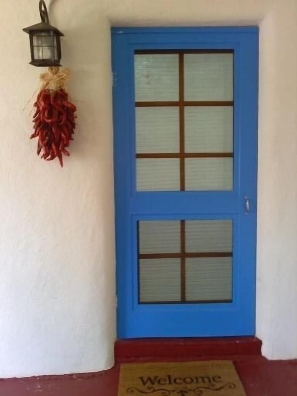 Entry way and covered porch from private parking area.