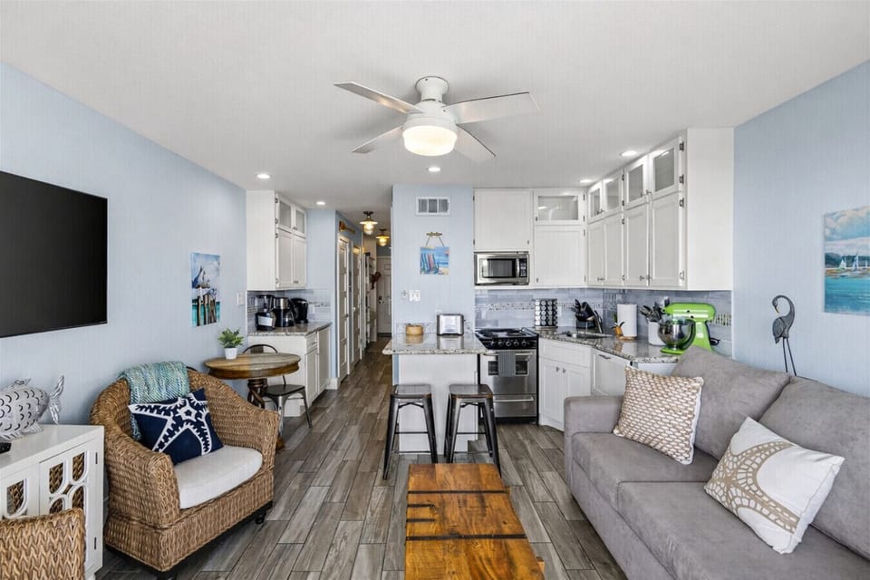 Bright, open, and beachy—this remodeled Casa Del Mar Galveston condo flows from the living room straight into a fully stocked kitchen.