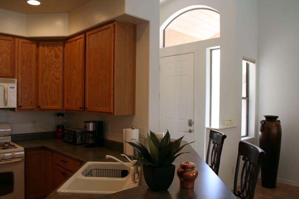 Kitchen with bar and bar stools