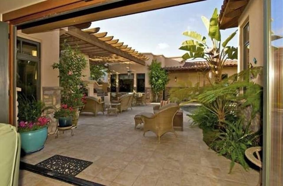 View of the backyard from the living room which has a window wall that opens
