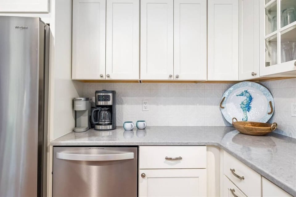 There is a Keurig and drip coffee machine as well as teas and other coffee service items in the cupboards