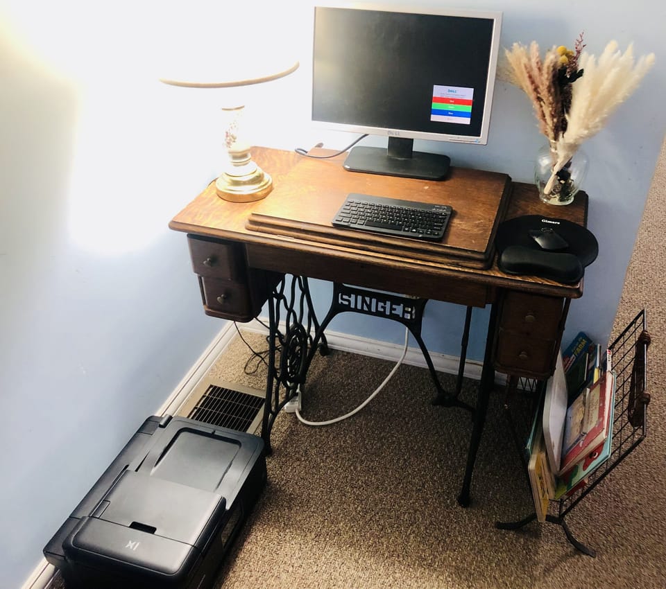 Office desk and printer located in the dinning room corner.