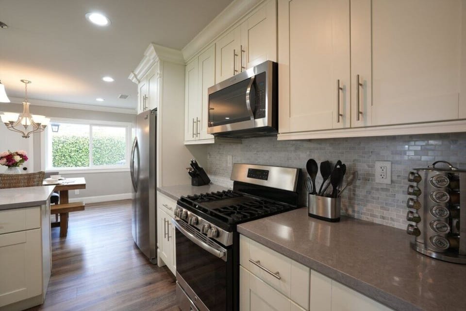 Open-concept kitchen with stainless steel appliances view 4